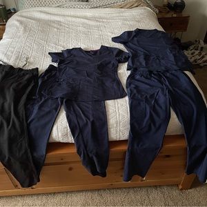 Petite size small scrubs. Lightly used. Two sets navy blue and one black pant.